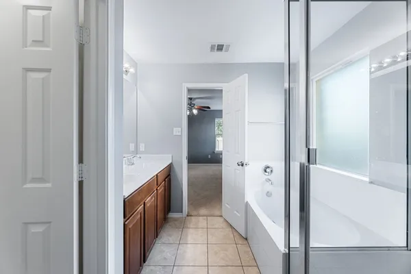 a hallway with cabinets and a sink