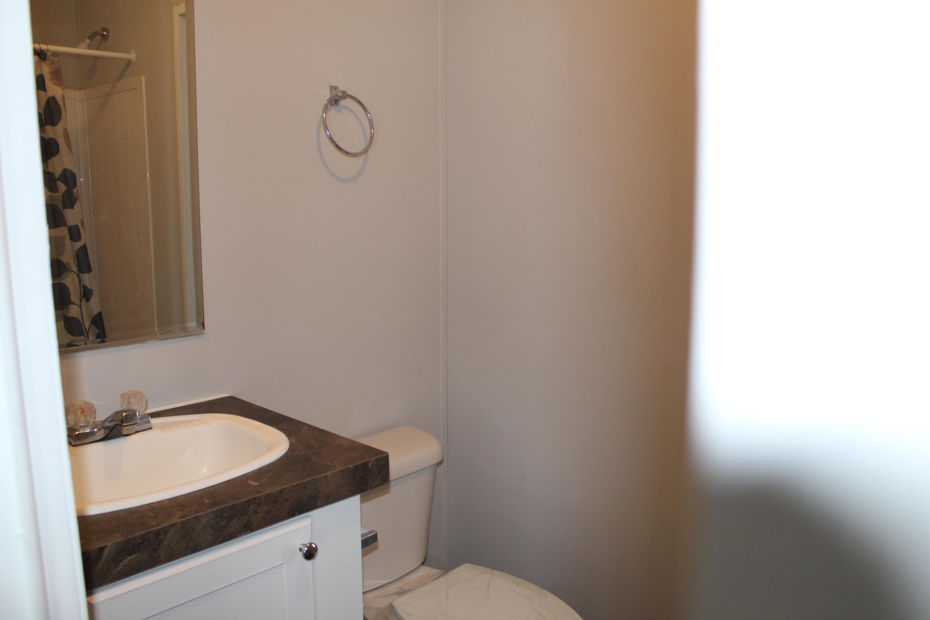 5072 Griffith Mill Road Holt, FL 32564 - Photo 16 of 22 a bathroom with a granite countertop sink and a toilet