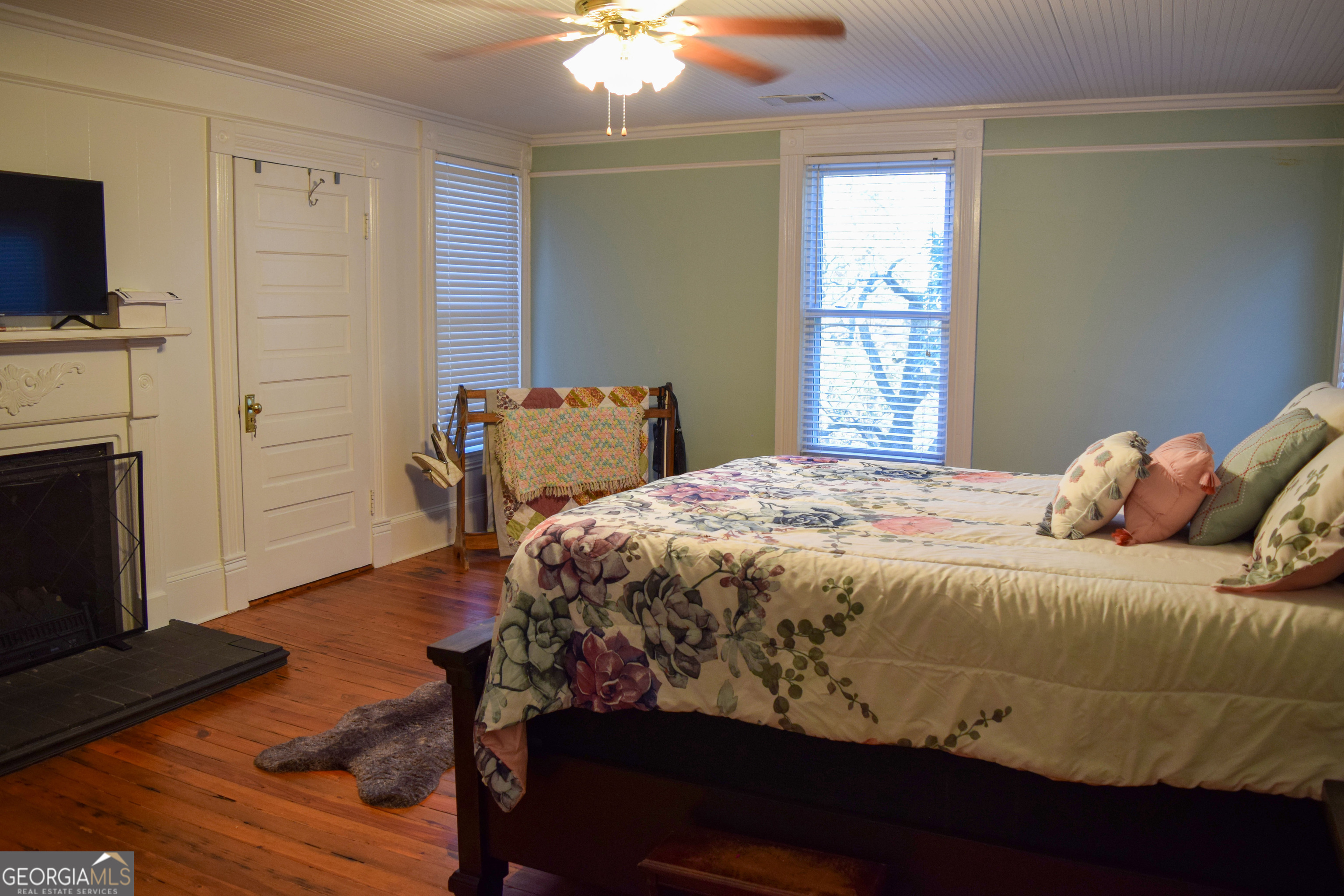 6464 Danburg Road Tignall, GA 30668 - Photo 12 of 23 a bedroom with a bed and a fireplace