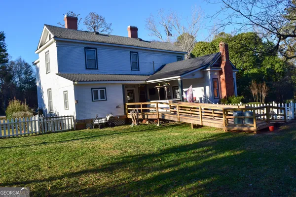 a front view of a house with a yard table and chairs