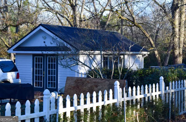 a front view of house with a garden