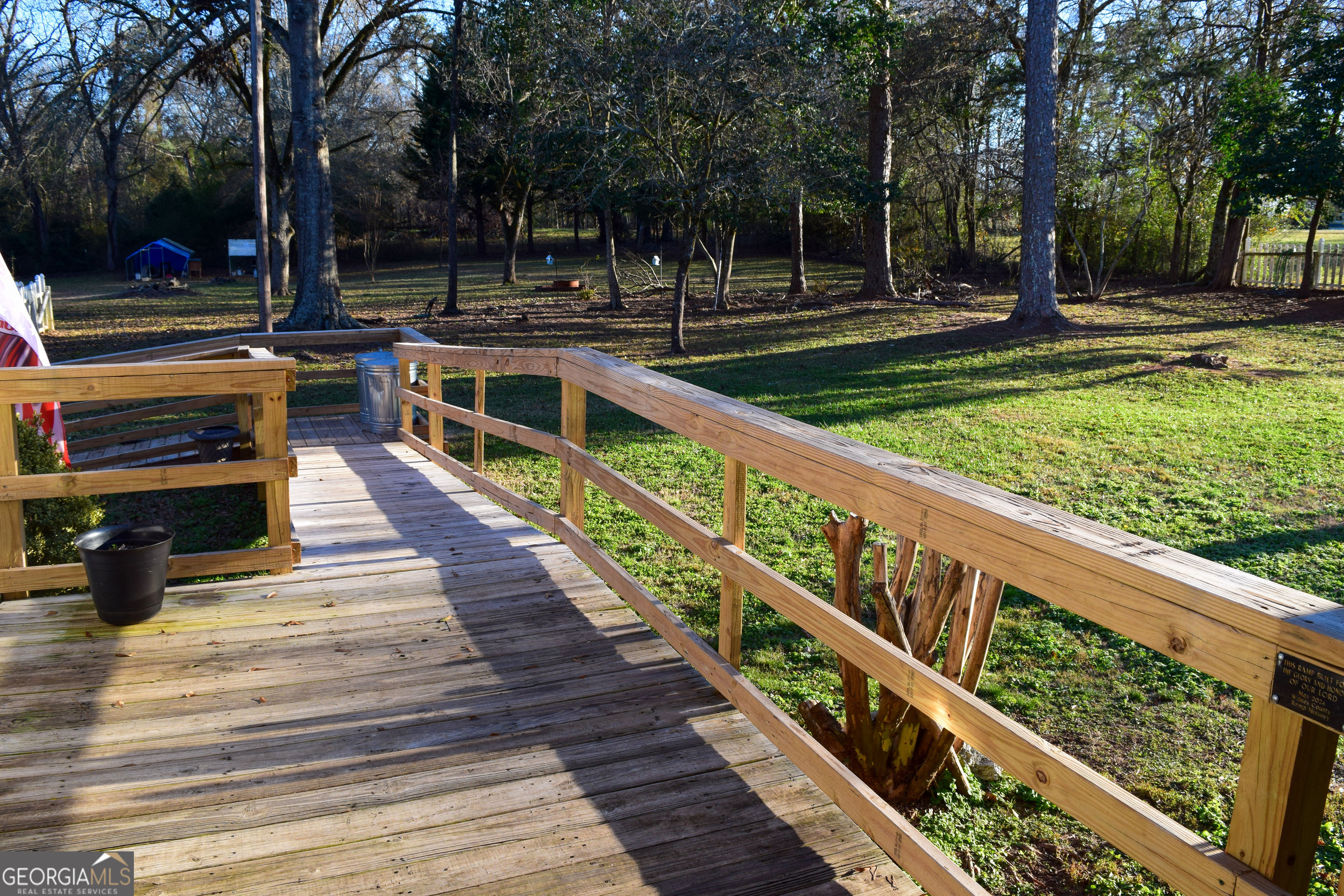 6464 Danburg Road Tignall, GA 30668 - Photo 21 of 23 a view of a deck with chairs next to a yard
