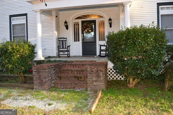 a front view of a house with a garden