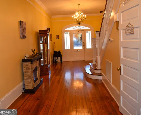 a view of a livingroom with furniture wooden floor and front door