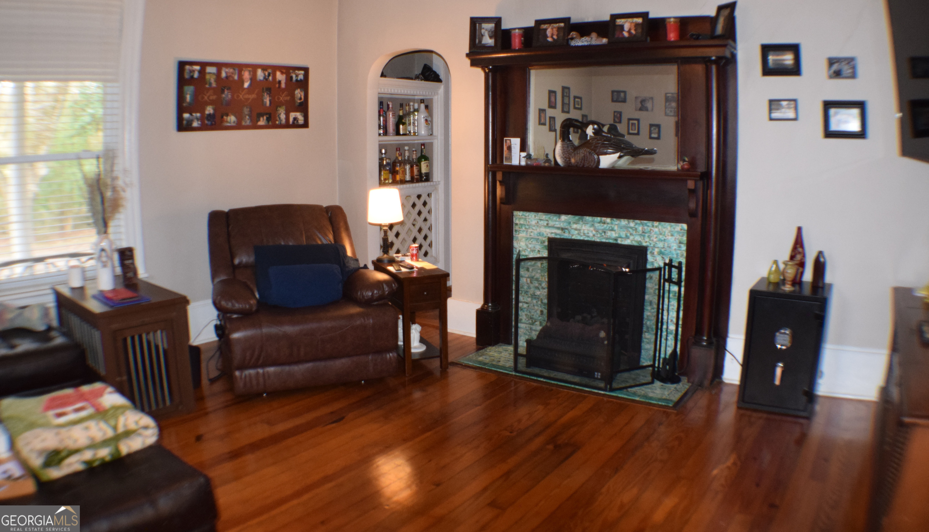 6464 Danburg Road Tignall, GA 30668 - Photo 6 of 23 a living room with furniture and a fireplace
