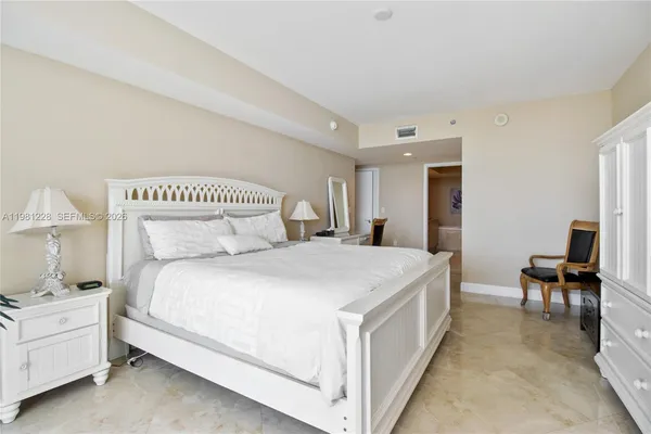 a bedroom with a bed and a chair