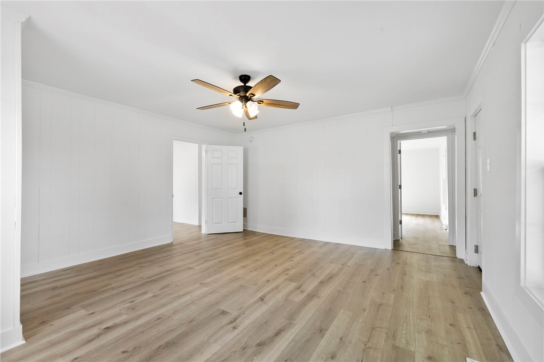 201 South 8th Street Easley, SC 29640 - Photo 21 of 28 Gleaming wood-look floors complement clean white paneled walls and classic molding details.