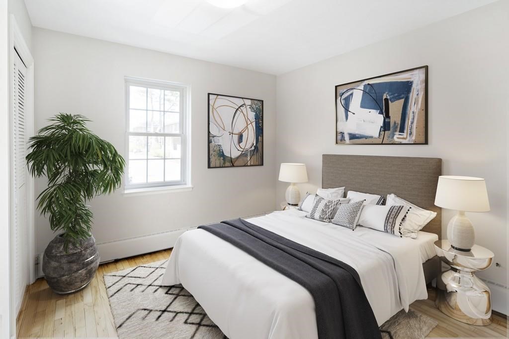 23 Hammond Pond Parkway, Unit 2 Newton, MA 02467 - Photo 11 of 21 a bedroom with a bed and a window
