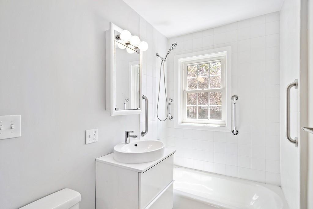 23 Hammond Pond Parkway, Unit 2 Newton, MA 02467 - Photo 14 of 21 a bathroom with a sink toilet and shower