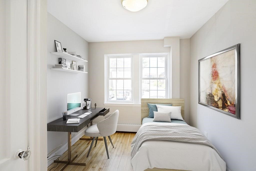 23 Hammond Pond Parkway, Unit 2 Newton, MA 02467 - Photo 15 of 21 a bedroom with a bed and a table