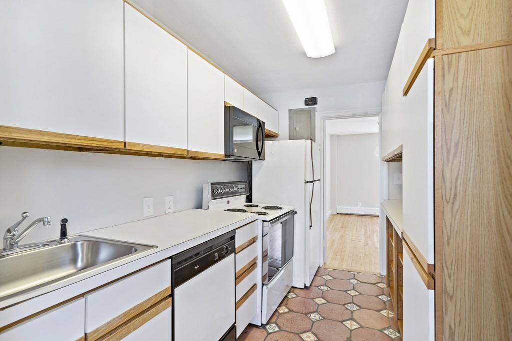 23 Hammond Pond Parkway, Unit 2 Newton, MA 02467 - Photo 9 of 21 a kitchen with a sink stove and refrigerator