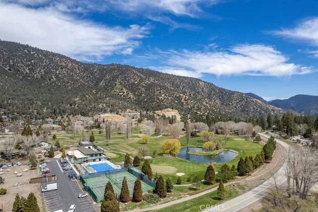 an aerial view of a house with a yard and lake view