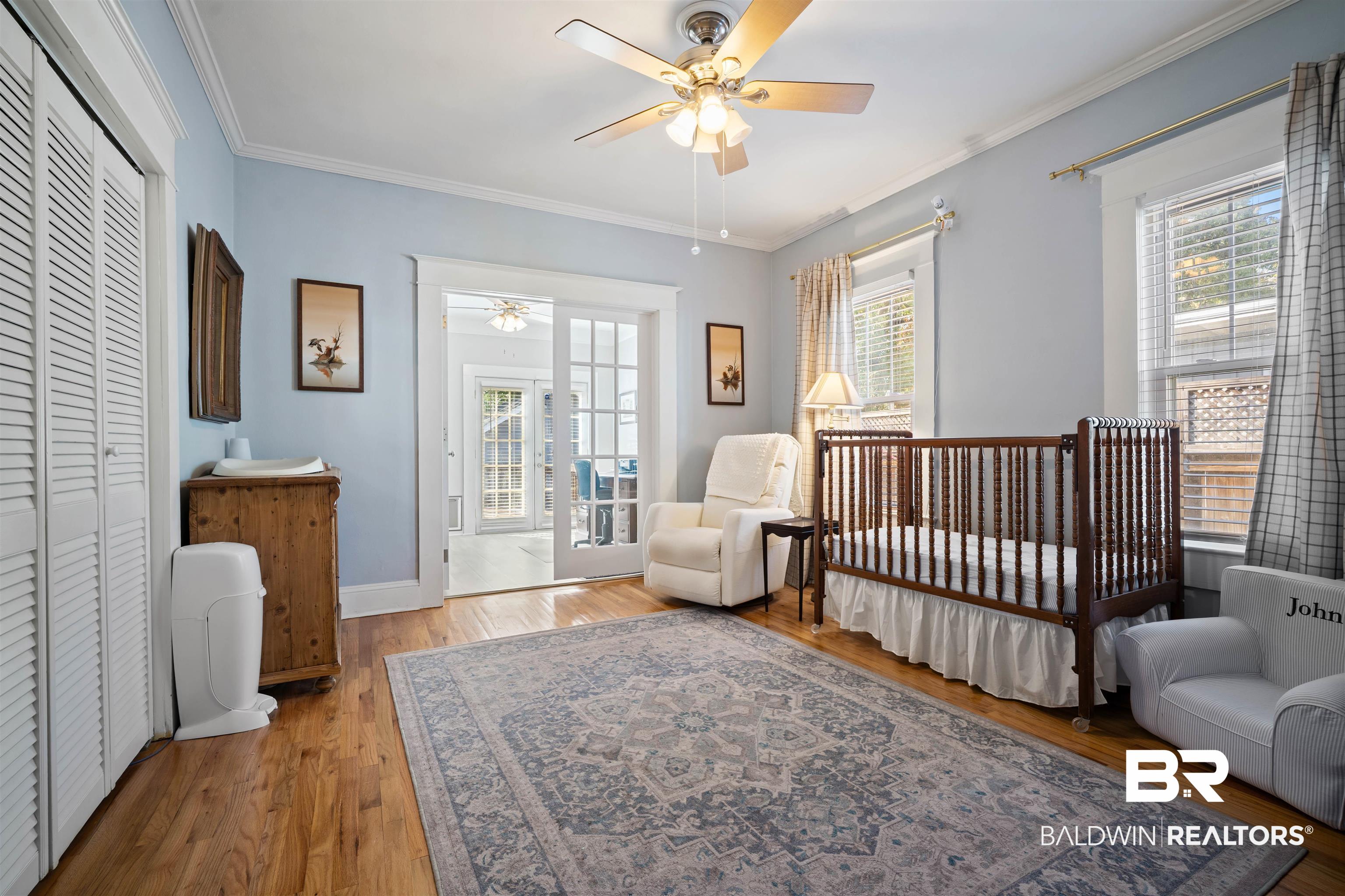 168 Mohawk Street Mobile, AL 36606 - Photo 24 of 31 Bedroom featuring light wood-style flooring, a ceiling fan, crown molding, a closet, and a nursery area