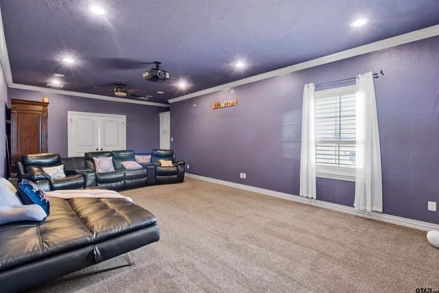 a living room with furniture a ceiling fan and a window