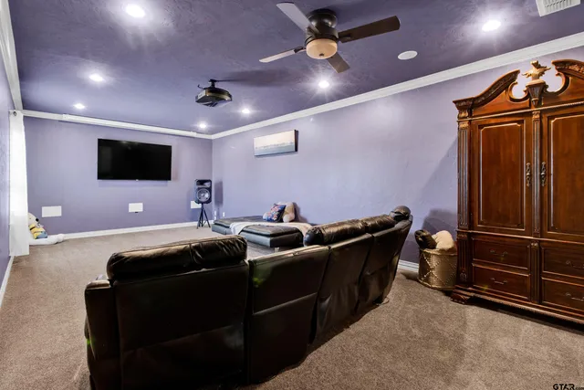 a hallway with a couch and a flat screen tv
