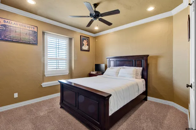 a bed sitting in a bedroom next to a window