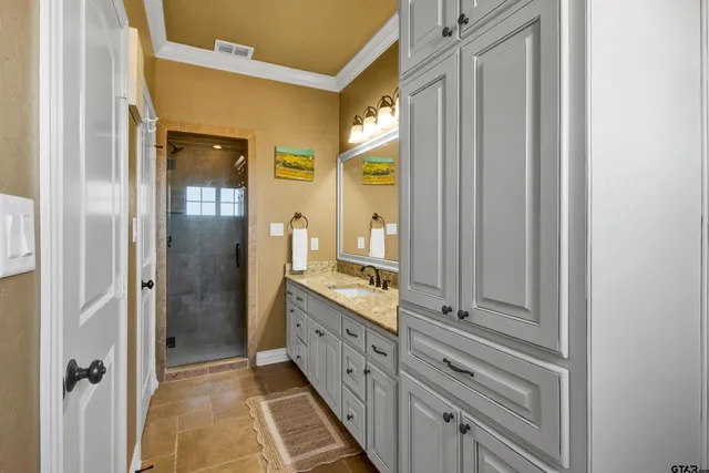 a bathroom with a double vanity sink and mirror