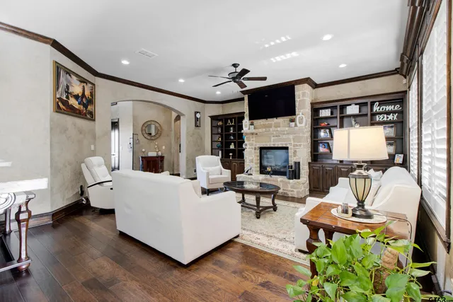 a living room with furniture fireplace and flat screen tv