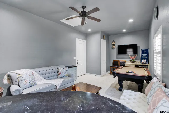 a bedroom with furniture and a flat screen tv