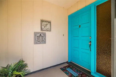 a view of a hallway with front door and wooden floor