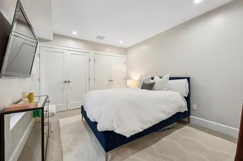 a bedroom with a bed and a flat screen tv