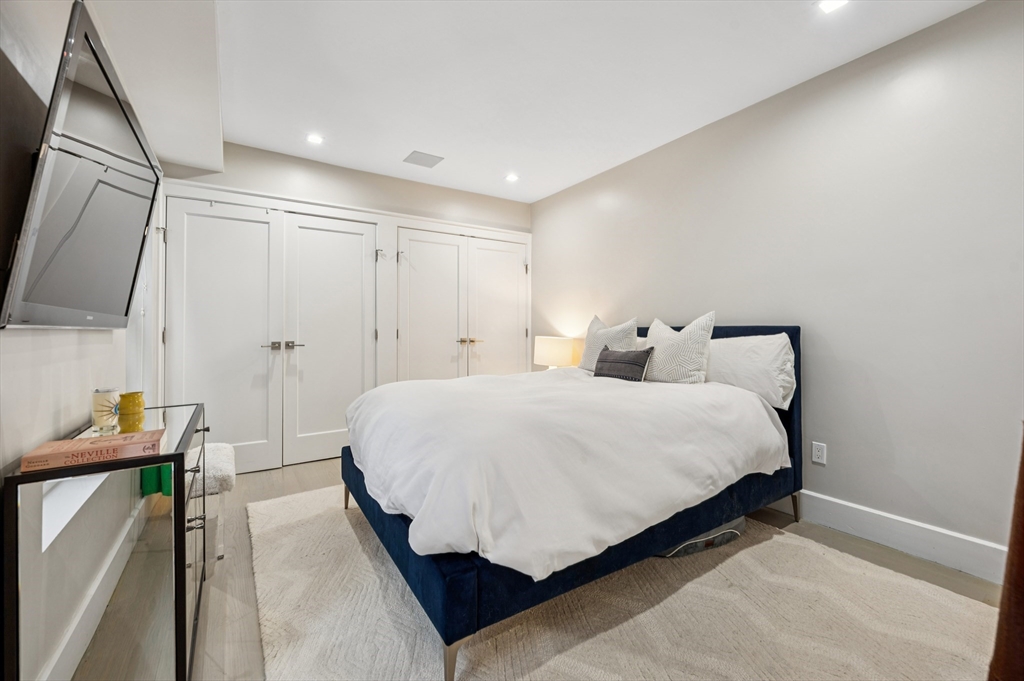 27 Mercer Street, Unit 1 Boston, MA 02127 - Photo 14 of 21 a bedroom with a bed and a flat screen tv