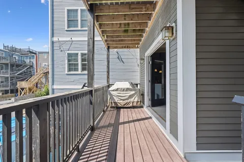 a view of a balcony with wooden floor