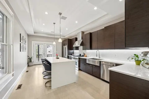 a kitchen with counter top space a sink stainless steel appliances and cabinets