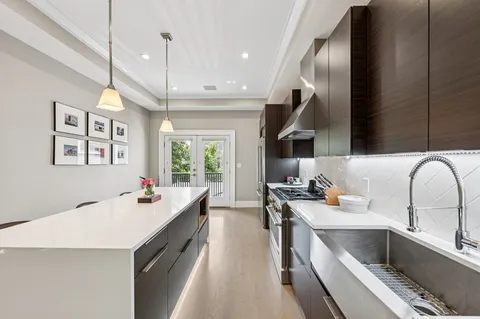a kitchen with a sink stove and cabinets