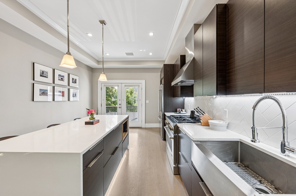 27 Mercer Street, Unit 1 Boston, MA 02127 - Photo 3 of 21 a kitchen with a sink stove and cabinets