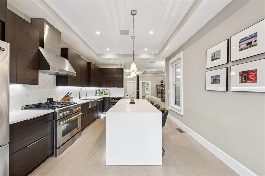 27 Mercer Street, Unit 1 Boston, MA 02127 - Photo 6 of 21 a kitchen with stainless steel appliances granite countertop a sink stove and refrigerator