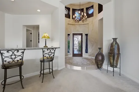 a view of a livingroom with furniture and a chandelier