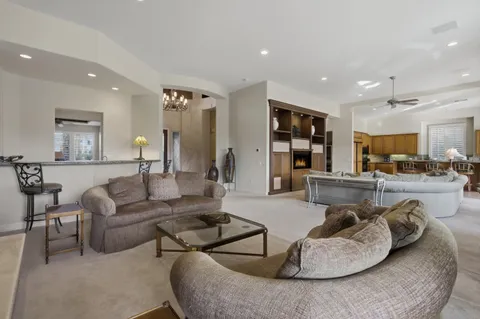 a living room with furniture and kitchen view
