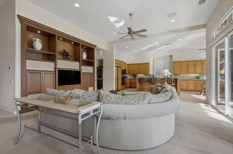 a living room with furniture kitchen view and a fireplace