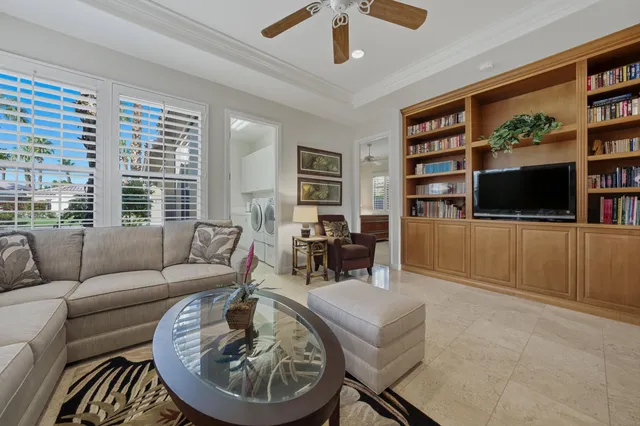 a view of a livingroom with workspace and a window