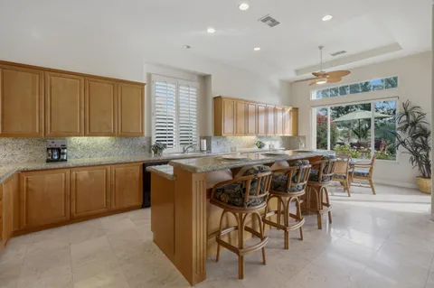 a kitchen with granite countertop sink cabinets and stainless steel appliances