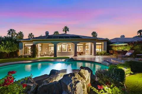 a front view of a house with swimming pool yard and outdoor seating