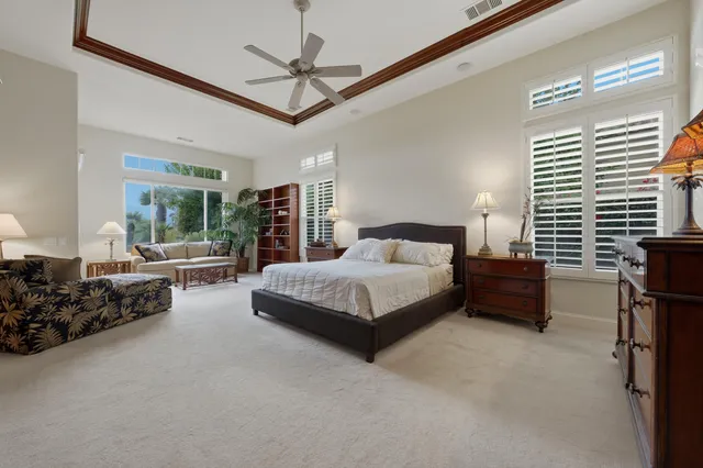 a bedroom with a bed closet and a large mirror