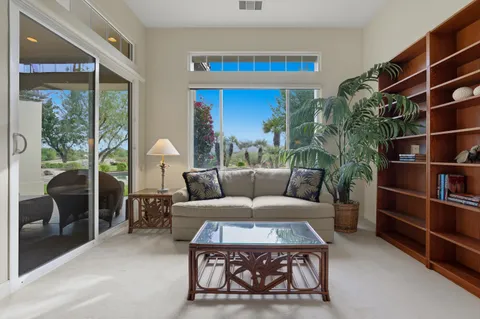 a bedroom with a bed closet and a large mirror