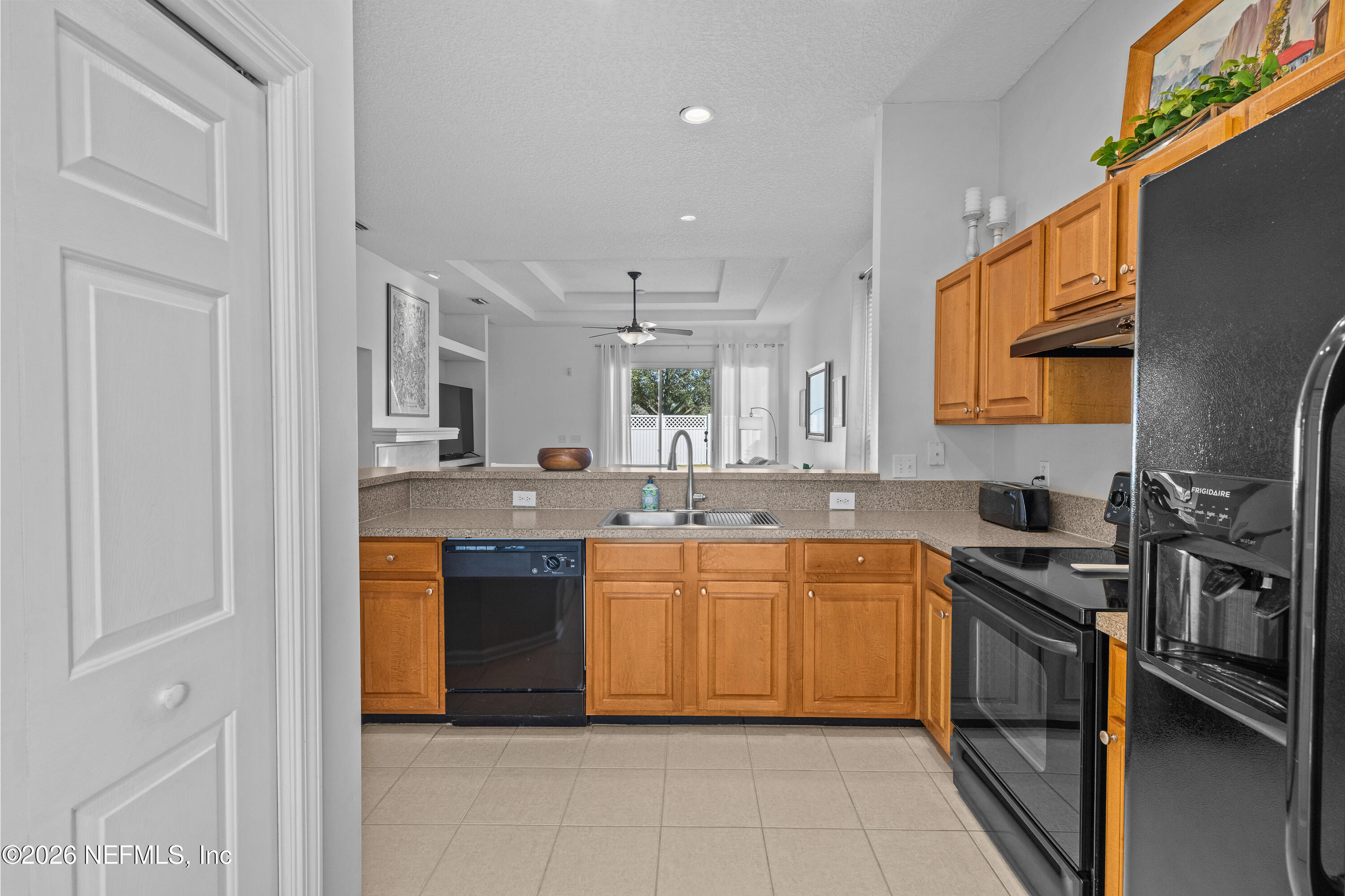 827 Briarcreek Road Jacksonville, FL 32225 - Photo 11 of 44 a kitchen with stainless steel appliances granite countertop a sink and dishwasher a stove top oven with wooden floor