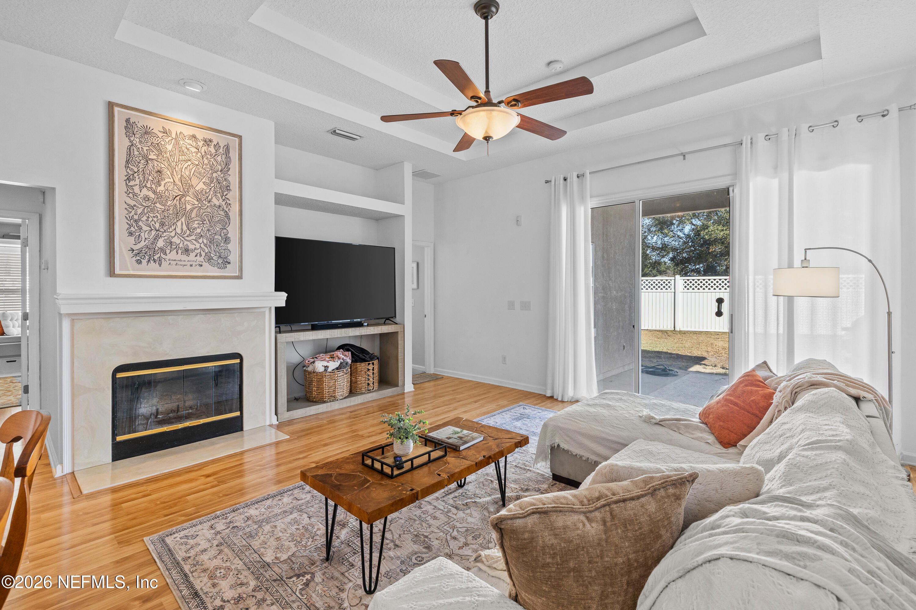 827 Briarcreek Road Jacksonville, FL 32225 - Photo 13 of 44 a living room with furniture a flat screen tv and a fireplace