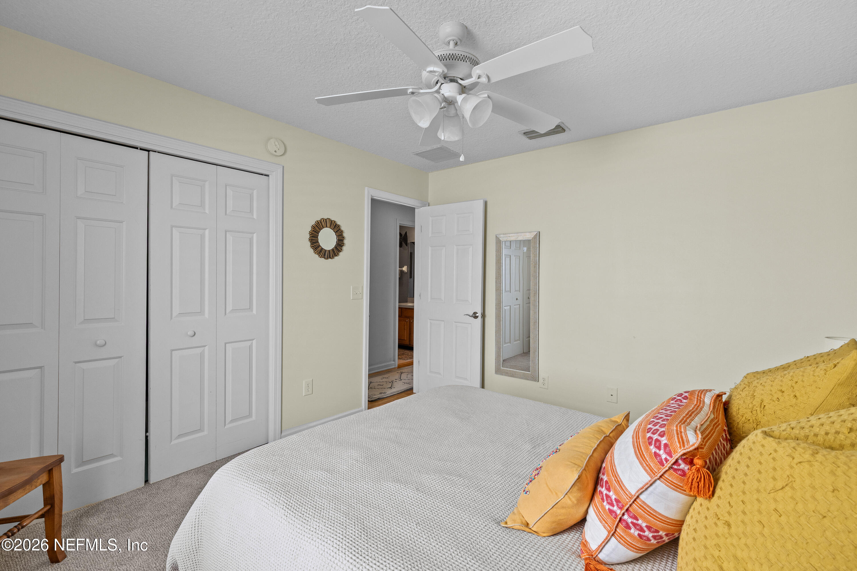 827 Briarcreek Road Jacksonville, FL 32225 - Photo 18 of 44 a bedroom with a bed and a chandelier