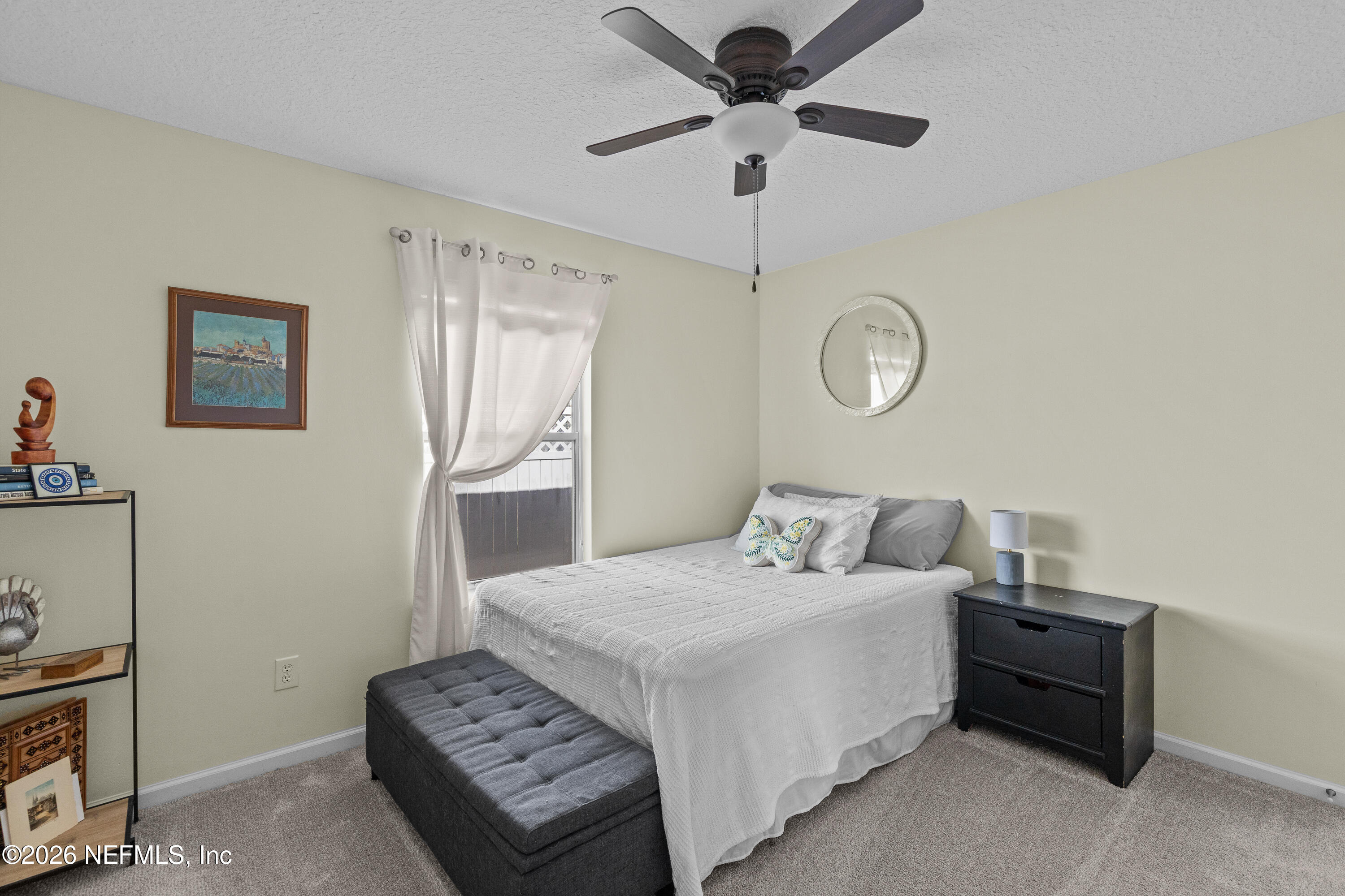 827 Briarcreek Road Jacksonville, FL 32225 - Photo 19 of 44 a bedroom with a bed and a chandelier