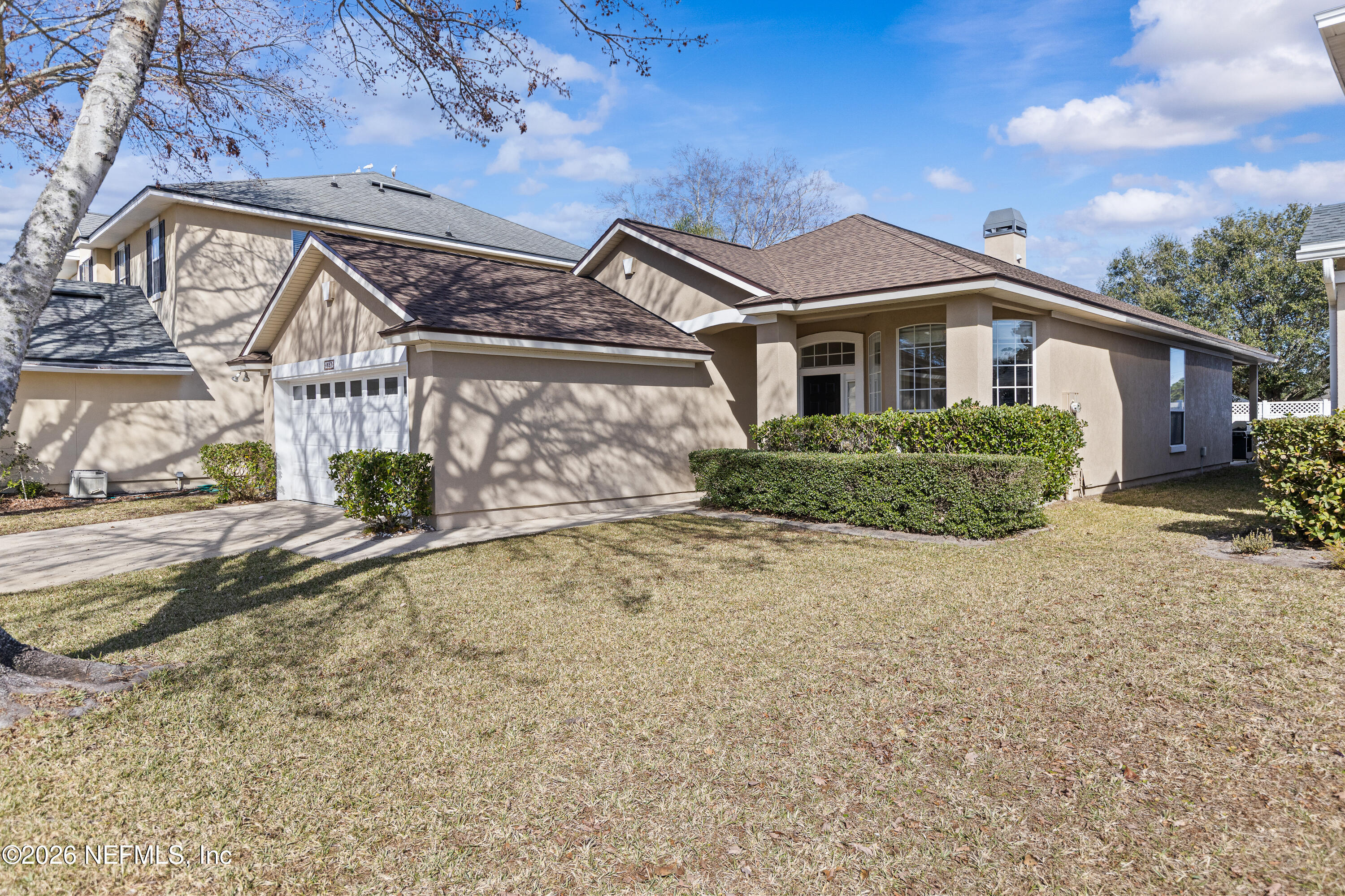 827 Briarcreek Road Jacksonville, FL 32225 - Photo 2 of 44 a front view of a house with a yard and garage