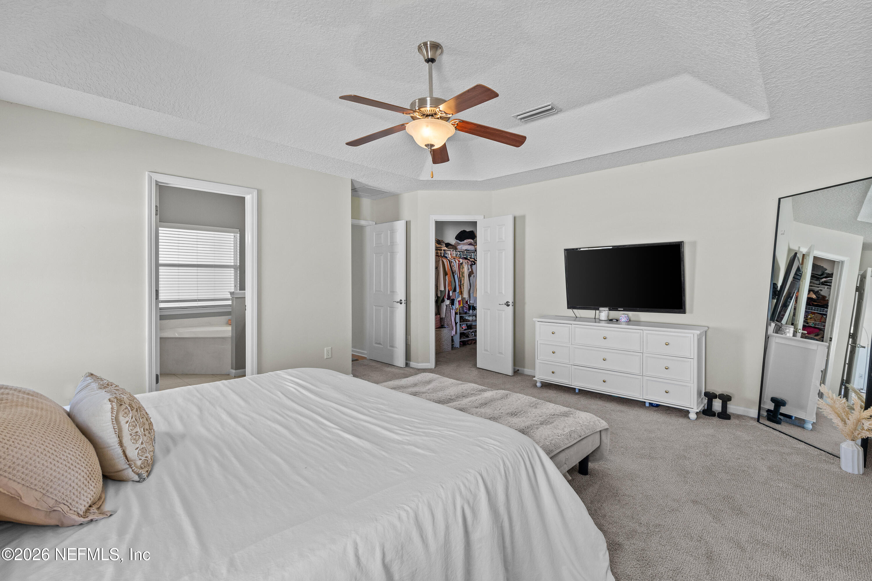 827 Briarcreek Road Jacksonville, FL 32225 - Photo 25 of 44 a bedroom with a bed and a flat screen tv