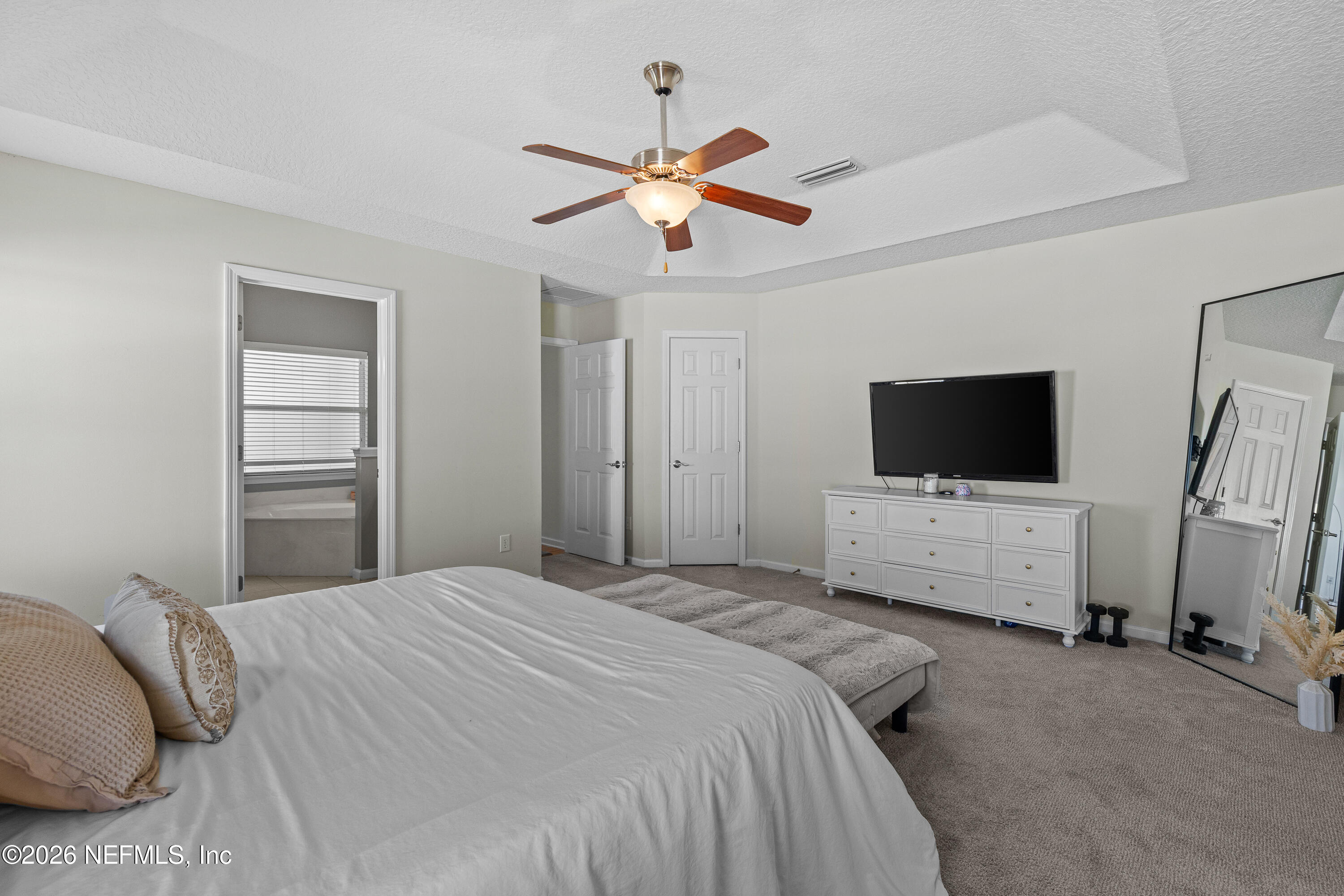 827 Briarcreek Road Jacksonville, FL 32225 - Photo 26 of 44 a bedroom with a bed and a flat screen tv