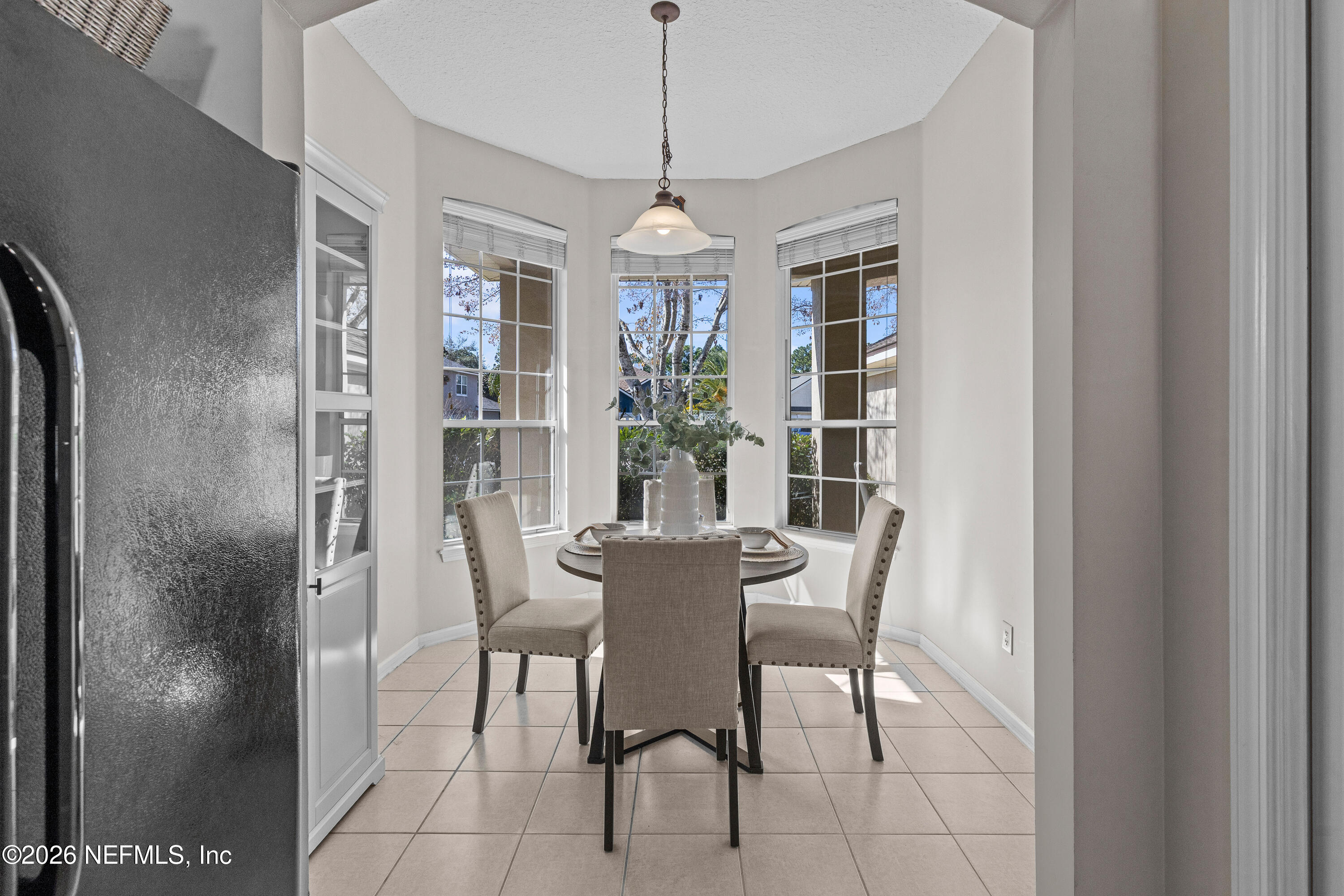 827 Briarcreek Road Jacksonville, FL 32225 - Photo 9 of 44 a dining room with furniture window entryway and wooden floor