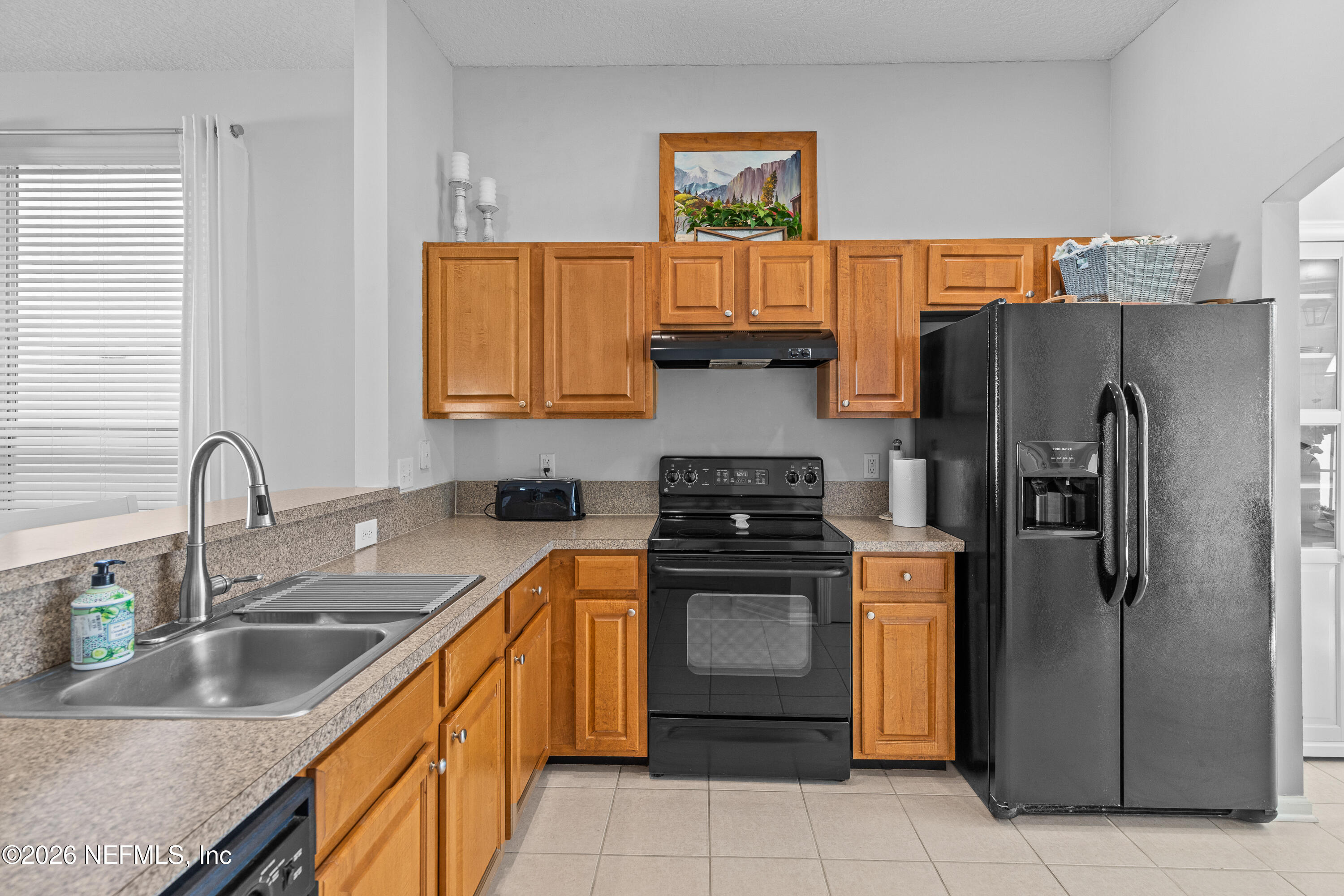 827 Briarcreek Road Jacksonville, FL 32225 - Photo 10 of 44 a kitchen with stainless steel appliances granite countertop a refrigerator sink and stove