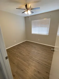 a view of a livingroom with wooden floor a fireplace and a window