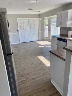 a view of kitchen with granite countertop window